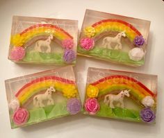 four soap bars with unicorns and flowers in them on top of a white table