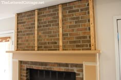 a brick fireplace in a living room under construction