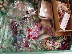 an open box filled with assorted items like candles, soaps and other things