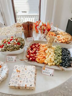 a table topped with lots of different types of food and snacks on plates next to each other