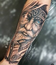 a man's arm with a tattoo on it and an image of a viking