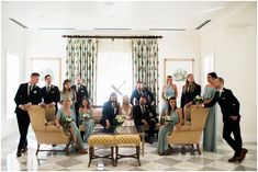 a group of people standing and sitting around a living room