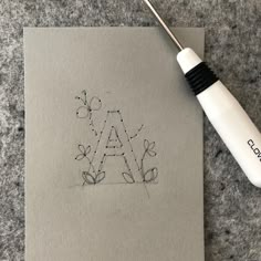 a drawing with the letter a on it next to a pen and paper that says aa