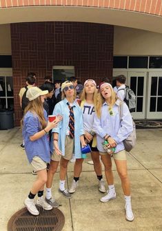 three girls are standing together in front of a building