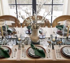 the table is set with dishes and place settings