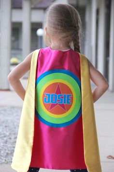 "Superkid Capes loves to celebrate and encourage! Our one-of-a-kind personalized superhero capes are great for so many occasions! Choose from 10 color combinations! See the options below, then let us know your special hero's name to add to this cape! INCLUDES: ONE Personalized superhero cape, double sided with 2 colors, customized with the name or phrasing of your choice. YOU CHOOSE (outside color/underside color) OPTION 1: TURQUOISE/PURPLE CAPE, white star, purple name OPTION 2: PINK/TURQUOISE Super Hero Capes For Kids, Purple Names, Purple Cape, Purple Gloves, Star Purple, Superhero Cape, Pink Cape, Blue Names, Girls Costumes