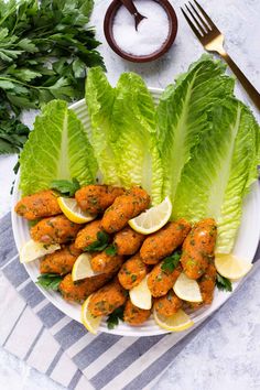 a white plate topped with lettuce and meatballs