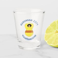 a shot glass next to a lemon on a white surface with the words christmas 2013 yournameme here