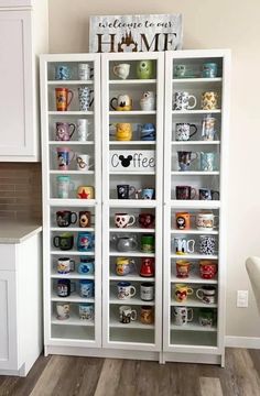 a white book case with coffee mugs on it