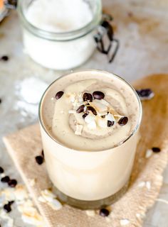 a smoothie in a glass with chocolate chips on top and the words vegan coconut cashew latte smoothie