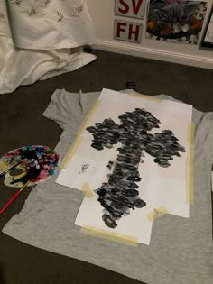 a t - shirt that has been made to look like a cross is laying on the floor