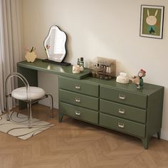 a green dresser sitting next to a mirror on top of a wooden floor in front of a window