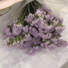 a bunch of purple flowers sitting on top of a table