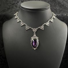 "This elegantly ornate necklace is made with antique silver tone centerpieces, featuring filigree and leaf details. Its mesmerizing design is accented with dazzling dark amethyst purple glass crystals with a large high quality faceted jewel hanging at its center.  Decorated portion is 8 1/2\" wide and 2 1/4\" tall in the very center.  Necklace length is adjustable with soldered stainless steel cable chain, lobster clasp and extender. If you would like a different length, please send us a message. If you don't see items with a color you want, feel free to ask about availability." Gothic Amethyst Necklace, Ornate Jeweled Necklaces, Ornate Formal Necklace With Oxidized Finish, Antique Silver Bridal Necklace For Formal Occasions, Bohemian Formal Necklaces With Jewels, Vintage Silver Bridal Necklace With Jewels, Silver Filigree Bridal Necklace For Formal Occasions, Antique Silver Bridal Necklace For Wedding, Formal Silver Filigree Bridal Necklace