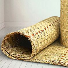 two pieces of woven material sitting on top of each other in front of a white wall