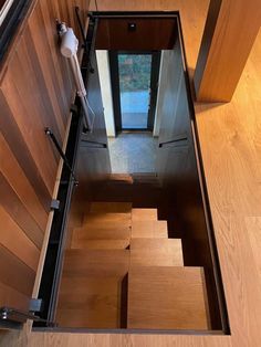 an open door on the side of a wooden staircase