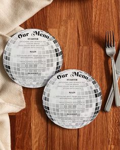 two plates and silverware on a wooden table