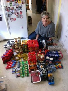 a woman sitting on the floor surrounded by food