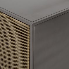 the side view of a metal cabinet with perfored mesh coverings on it