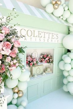 the entrance to colette's flower shop is decorated in pastel green and pink