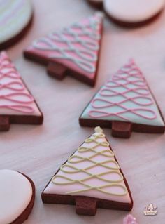 decorated cookies are arranged in the shape of christmas trees