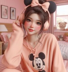 a woman with headphones sitting on a bed wearing a pink minnie mouse sweatshirt and pants