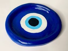 a blue bowl with an evil eye painted on it