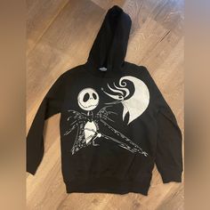 New Without Tags, Disney Kids Nightmare Before Christmas Hoodie Black, 100% Cotton Sweatshirt With Hood Size 14/16 White Print On Front, Plain Black Back Join Jack Skellington, The Pumpkin King, As He Stumbles From Halloween Town To Christmas Town And Becomes Awed By The Festive Winter Holiday. Help Jack, Sally, Zero The Dog, And The Other Citizens Of Halloween Town Celebrate And Successfully Take Over Christmas From Santa Clauswithout Getting Oogie Boogie Involved This Time! Get Your Little One Disney Style Sweatshirt With Character Print For Winter, Disney Character Print Sweatshirt For Winter, Disney Character Print Winter Sweatshirt, Black Disney Sweatshirt For Winter, Black Disney Winter Sweatshirt, Disney Hoodie With Cartoon Print For Winter, Disney Style Winter Hoodie With Cartoon Print, Disney Cartoon Print Hoodie For Winter, Disney Cartoon Print Winter Hoodie