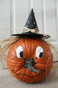 a pumpkin with a witch's hat on its head