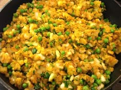 a pan filled with rice and peas on top of a table