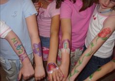 several children with their hands painted in different colors and designs, all holding onto each other