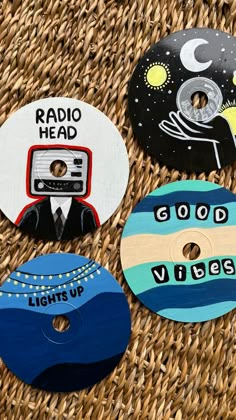 four different types of buttons on a wicker table top with the words radio head and good vibes written on them