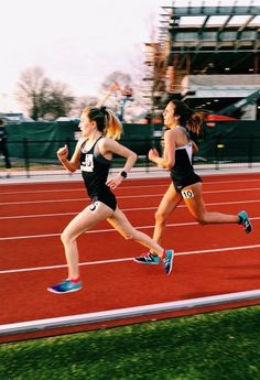 two women running on a race track