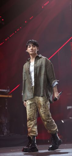 a young man standing on top of a stage