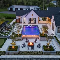 an aerial view of a house with a fire pit in the middle and seating around it