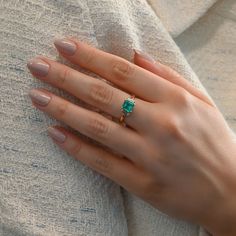 Presenting our vintage emerald and diamond three stone ring. Featuring an enchanting 1.3 carat emerald flanked by two emerald-cut diamonds, it's a classic piece radiating sophistication. Available in 18K Yellow Gold Available in a size 7 Ring can be resized between sizes 6-8 for an additional fee. Please contact our team at info@stephaniegottlieb.com for more information. Green Emerald weight = 1.30 carats Diamond weight = 0.43 carats Diamond quality = FG color, VS clarity Origin = Germany Estim Green Diamond Ring With Radiant Cut And Prong Setting, Radiant Cut Emerald Ring For Proposal, Brilliant Princess Cut Emerald Ring For May Birthstone, Radiant Cut Emerald Ring With Center Stone, Timeless Asscher Cut Green Emerald Ring, Green Three-stone Emerald-cut Emerald Ring, Green Three Stone Emerald Cut Emerald Ring, Three-stone Emerald Cut Green Emerald Ring, Gift Emerald Ring With Three Stones In Radiant Cut