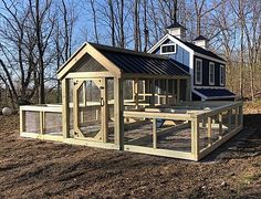 a chicken coop in the middle of a field