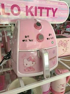 a pink hello kitty toaster sitting on top of a shelf