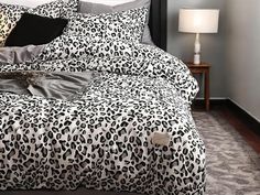 a black and white leopard print comforter on a bed