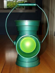 a green light sitting on top of a wooden table