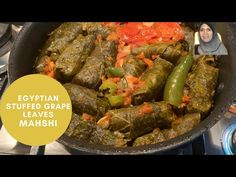 egyptian stuffed grape leaves mash in a pan with a woman looking at the camera