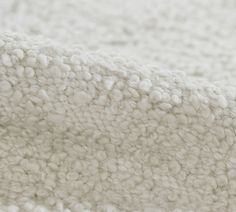 a close up view of the texture of a white rug or carpet with small circles on it