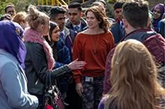 a group of people standing around each other