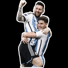 two soccer players hugging each other with their arms in the air