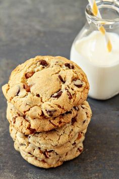 a stack of cookies next to a glass of milk