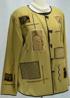 a mannequin wearing a yellow jacket with pictures on it