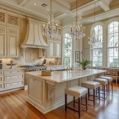 a large kitchen with an island and chandelier