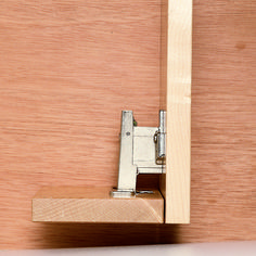 a close up of a wooden door hinge with a metal latch on the side