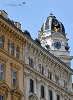 a large building with a clock on the top of it's face and windows