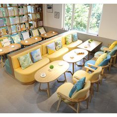 a library filled with lots of tables and chairs